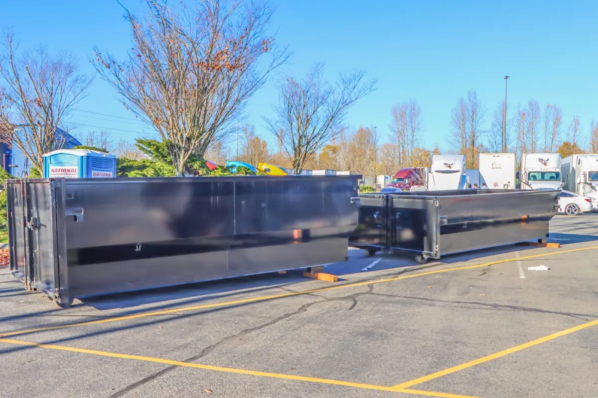 Professional dumpster rental service with roll-off container on residential driveway in Kenilworth